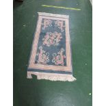BLUE GROUND EMBOSSED CHINESE STYLE RUG DECORATED WITH DRAGONS. 125 CM BY 68 CM