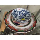 AN IRONSTONE CHINA PLATE DECORATED WITH A ORIENTAL SCENE, AND A BLUE AND WHITE BOWL WITH CHARACTER