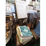 AN EXTENDING MUSIC STAND WITH A SELECTION OF SHEET MUSIC.