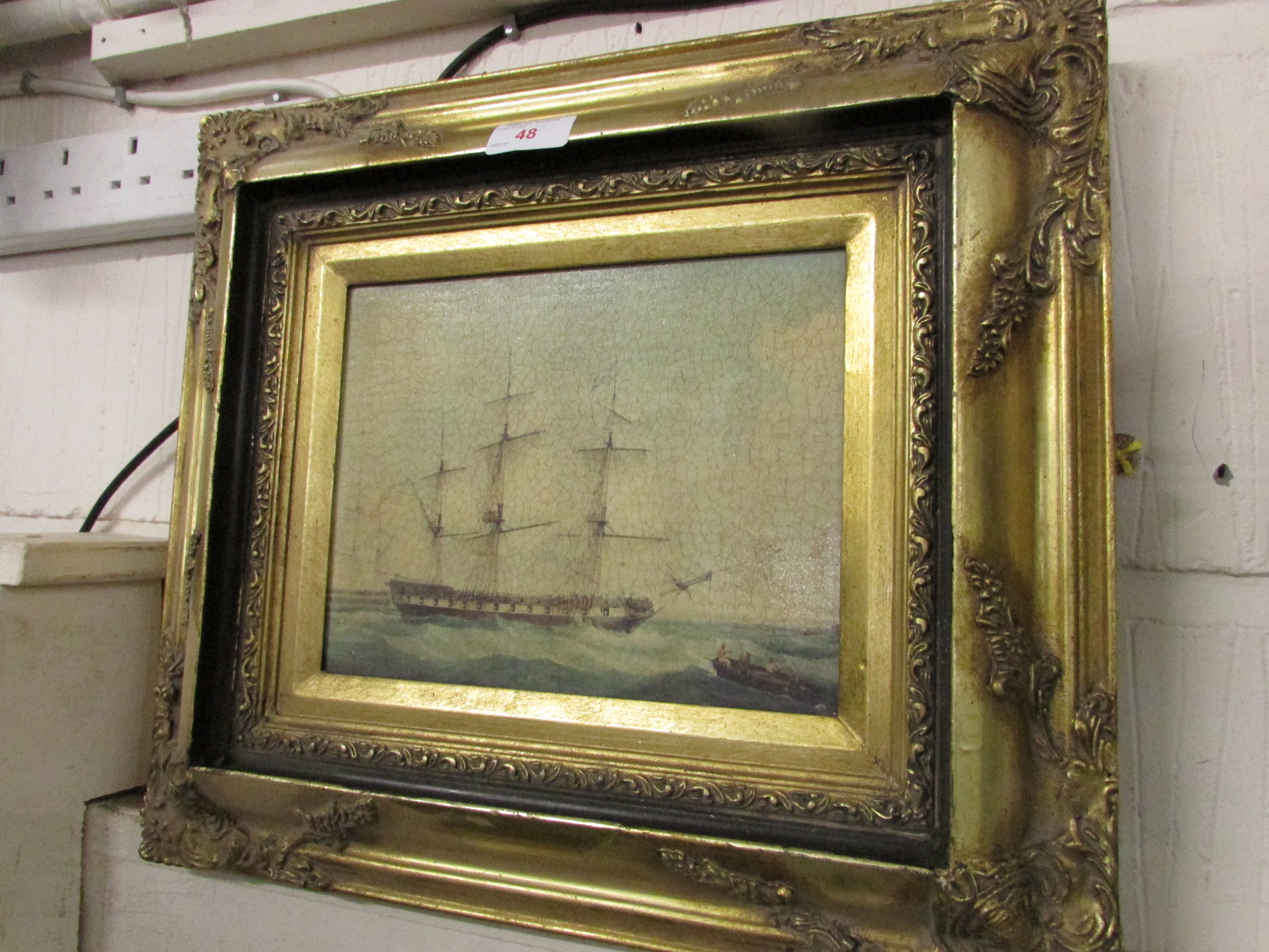 REPRODUCTION ANTIQUE-EFFECT PRINT OF A SAILING SHIP IN A GILT FRAME