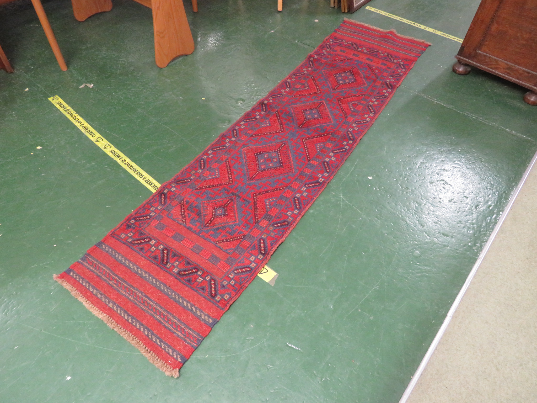 RED GROUND MESHWANI FLOOR RUNNER 233 BY 54 CM.