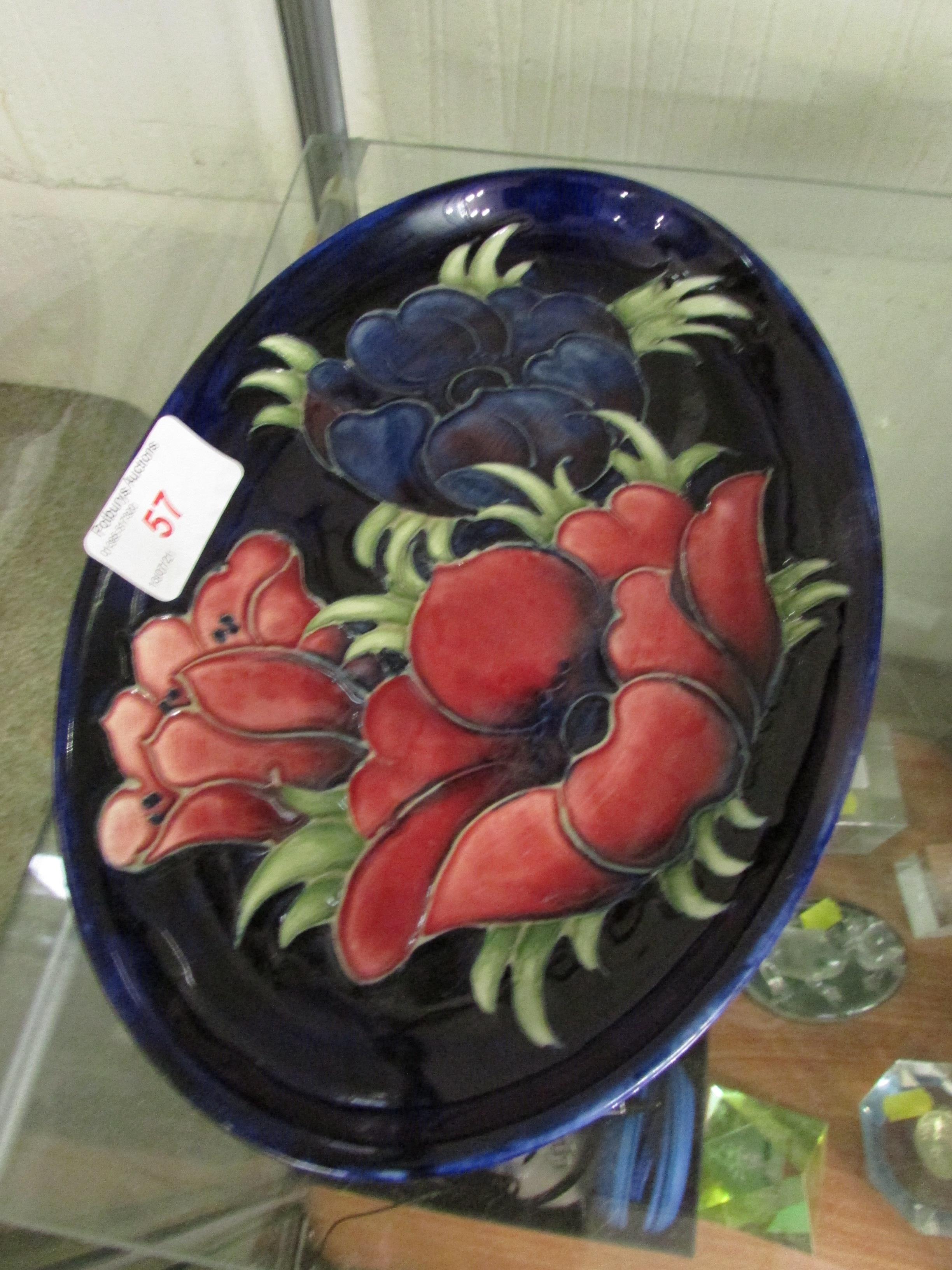 MOORCROFT POTTERY SHALLOW OVAL DISH DECORATED WITH FLOWERS , SIGNATURE TO BASE.