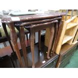 NEST OF THREE MAHOGANY VENEERED OCCASIONAL TABLES WITH GLASS TOPS.