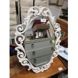 OVAL TABLE MIRROR WITH A WHITE PAINTED FOLIATE FRAME.