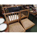 A SET OF FOUR EARLY 20TH CENTURY MID WOOD FRAMED DINING CHAIRS WITH DROP IN SEAT PADS.