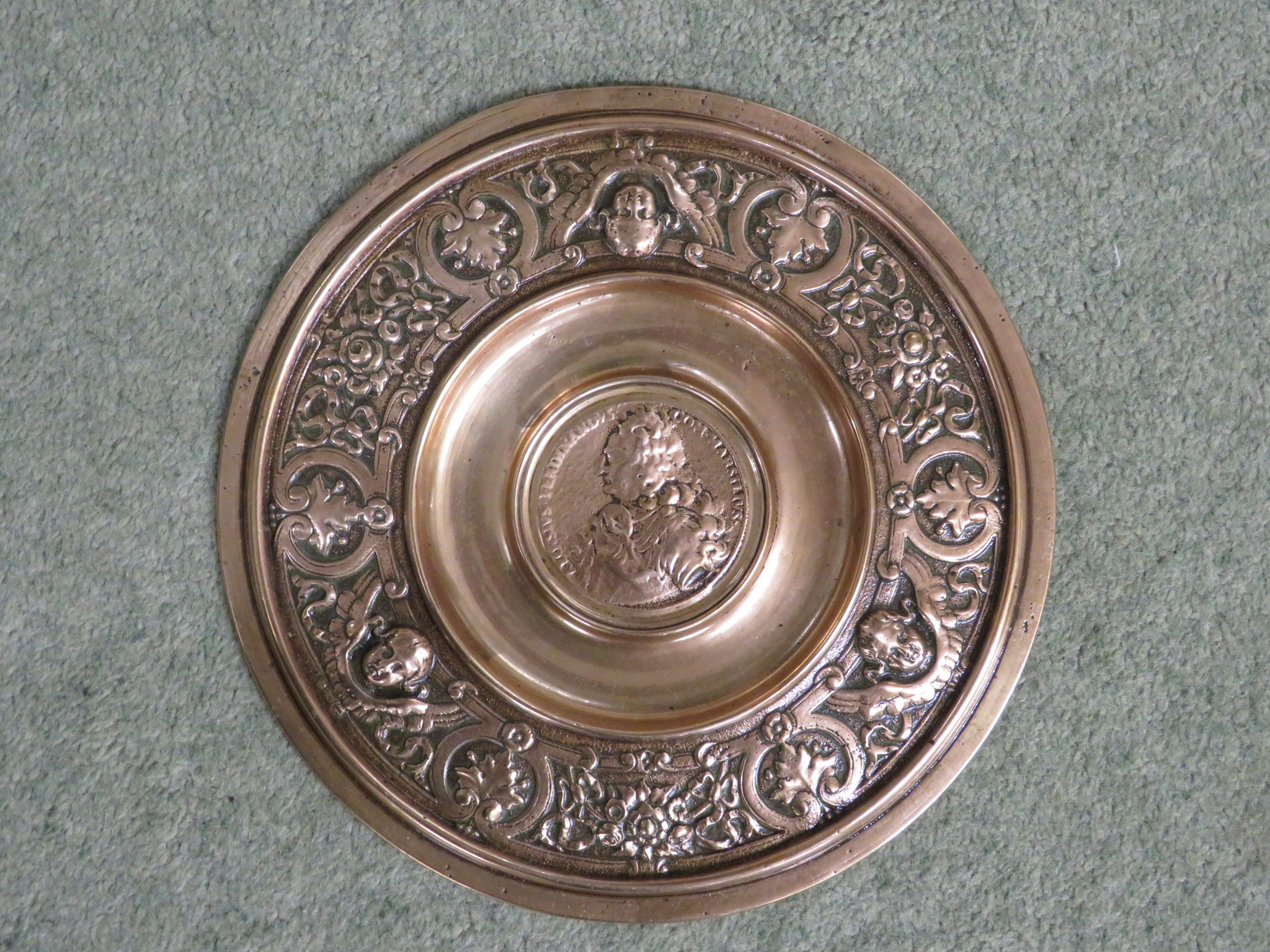 EMBOSSED BRASS ROUNDEL, PERHAPS MADE FROM A RECLAIMED SHELL CASING