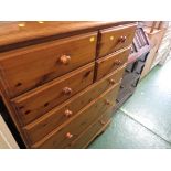 HONEY PINE CHEST OF FOUR SHORT OVER THREE LONG DRAWERS, ON CASTERS