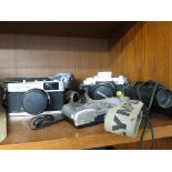 OLYMPUS OM30 CAMERA, OLYMPUS TRIP CAMERA, NIKON DIGITAL CAMERA , AND A PAIR OF 10X25 BINOCULARS.