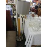VALSAN BRONZED METAL FLOOR STANDING LAMP WITH CANDLE STYLE FITTING AND A BEIGE SHADE.