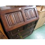 STAINED OAK THREE DRAWER BUREAU.