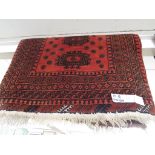 RED GROUND MIDDLE EASTERN RUG SIX MARGINS AND FOUR MEDALLIONS 104 BY 150 CM