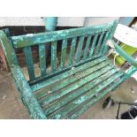 A WOODEN PARK BENCH PAINTED GREEN. (AF)