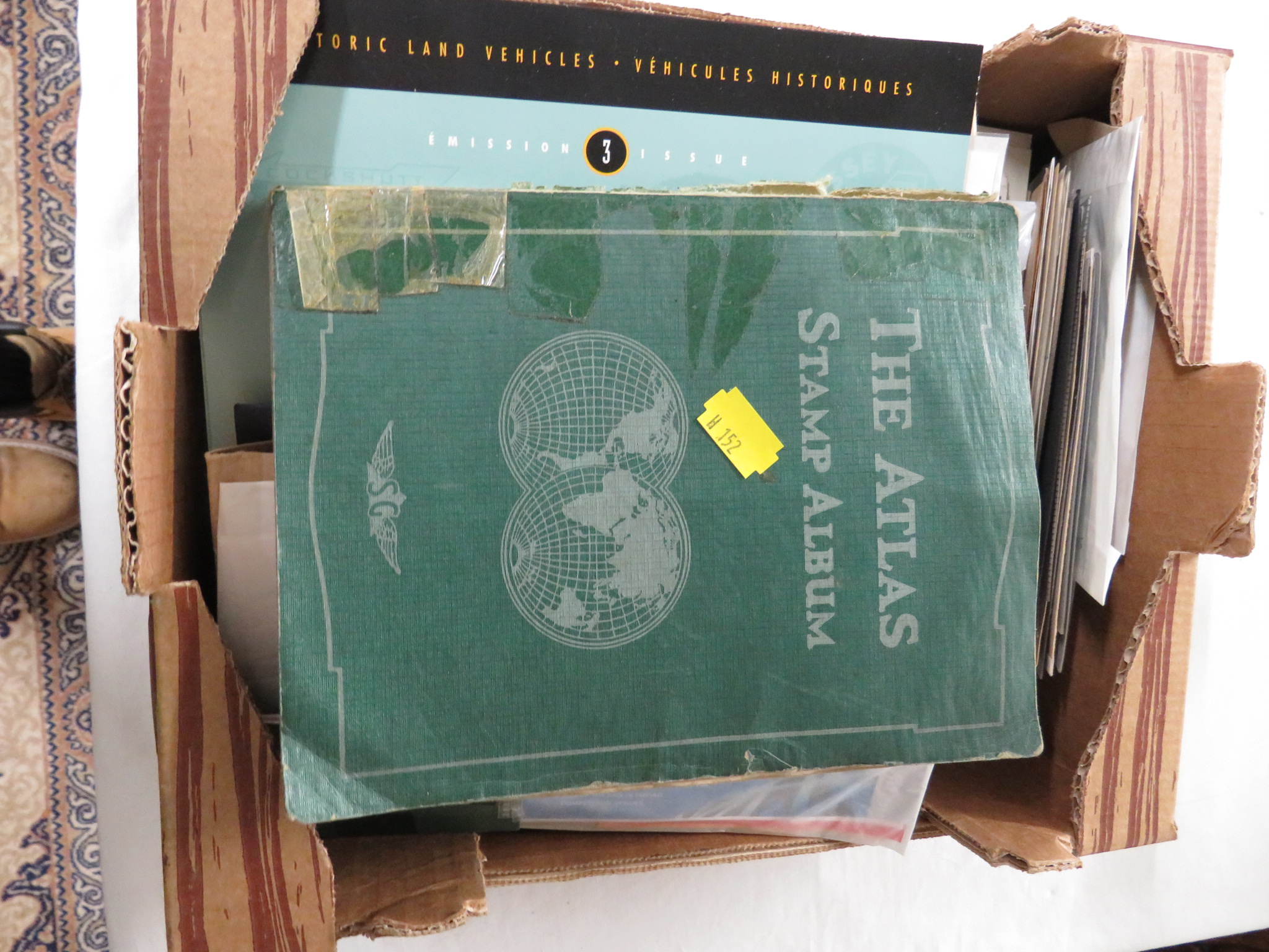 THE ATLAS STAMP ALBUM, A BLUE STOCK ALBUM, TRAFALGAR STAMP COLLECTION LIMITED EDITION ALBUM, AND A