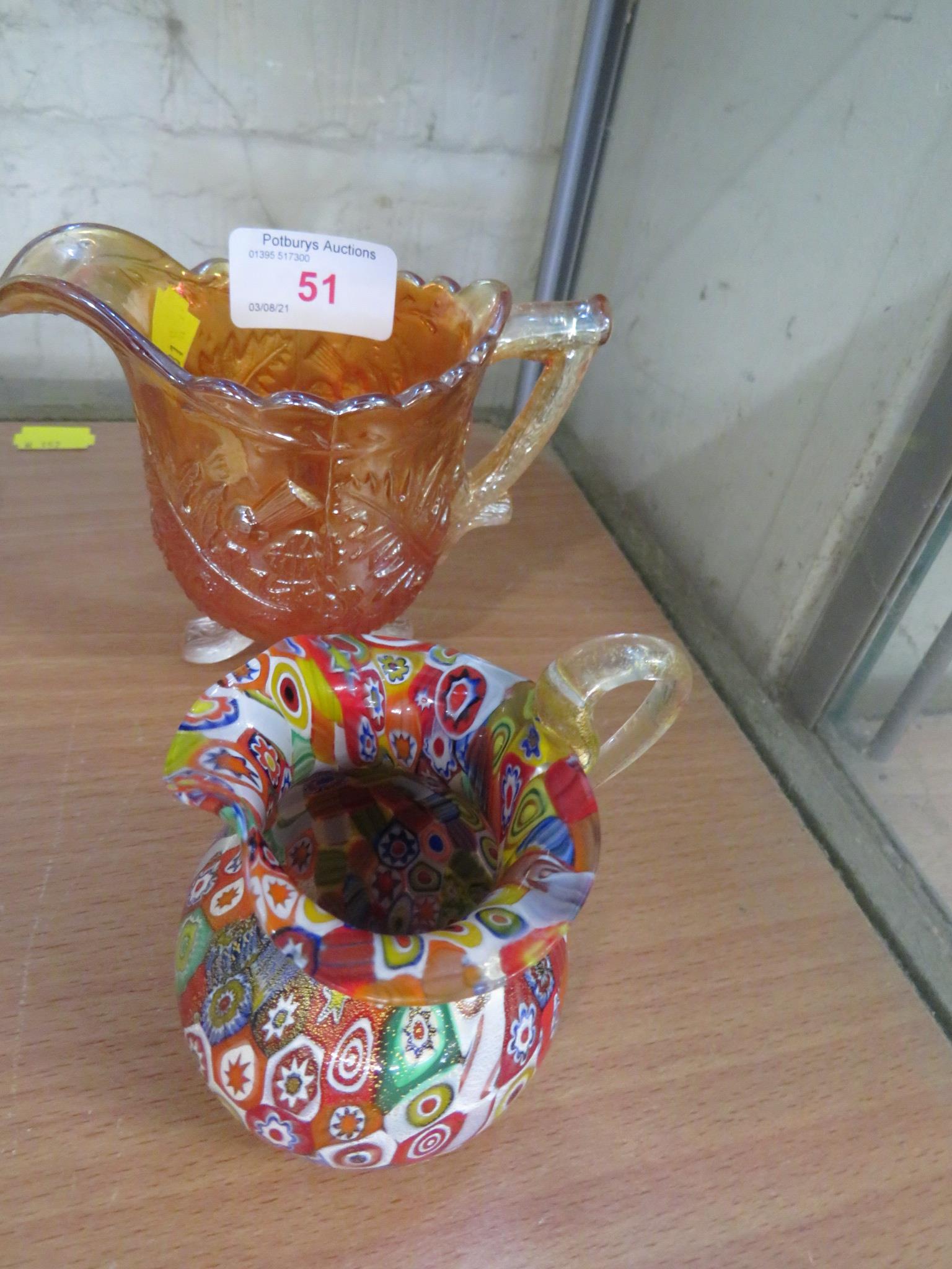 CARNIVAL GLASS JUG AND ONE OTHER COLOURED GLASS JUG.