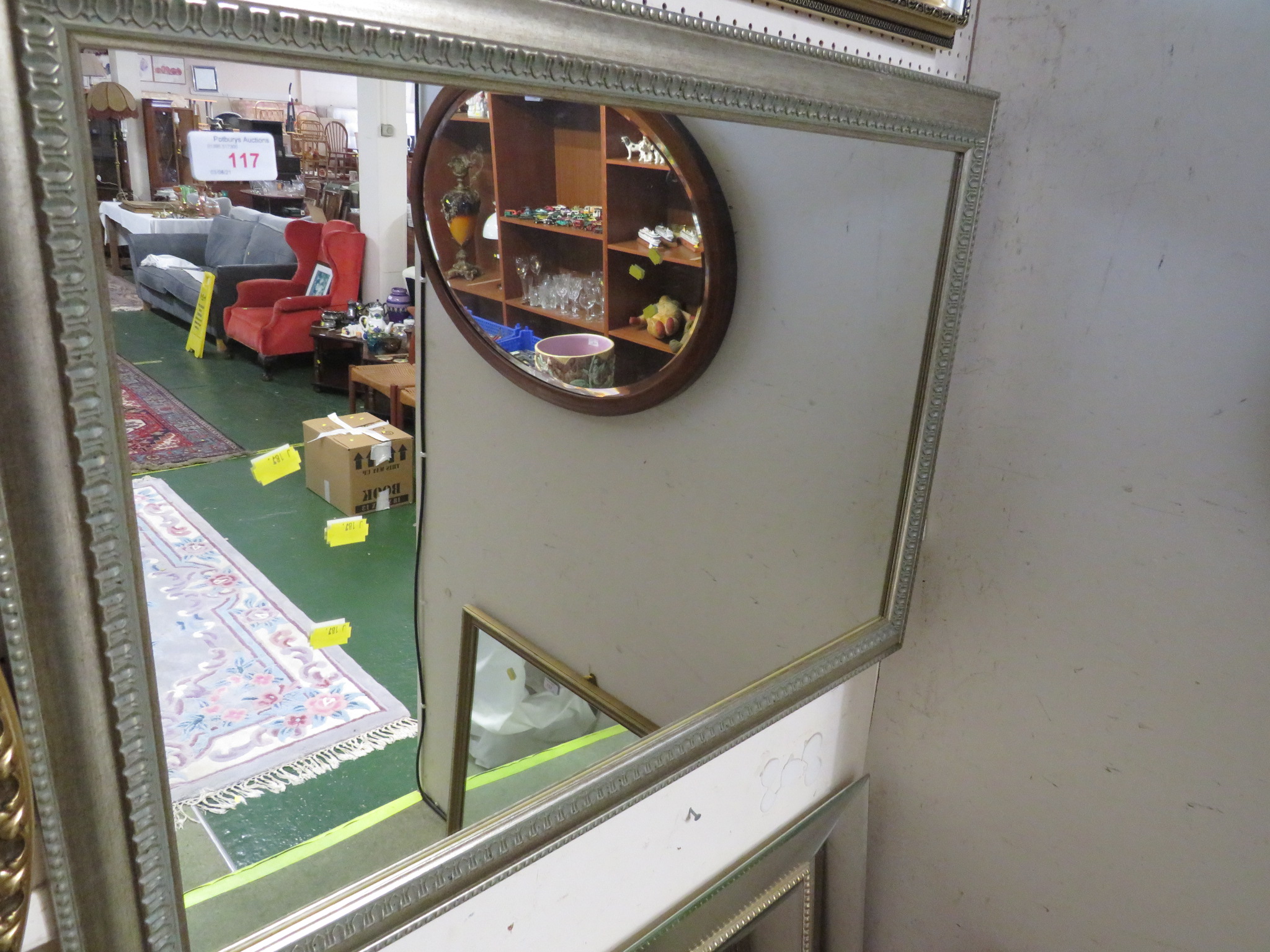 RECTANGULAR MIRROR IN A SILVER COLOURED FRAME.