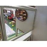 RECTANGULAR MIRROR IN A SILVER COLOURED FRAME.