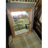 A SMALL RECTANGULAR MIRROR IN A PINE FRAME AND A MIRROR IN A STAINED FRAME.