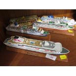 FOUR SCALE MODELS OF CRUISE SHIPS TOGETHER WITH ONE OTHER MODEL.