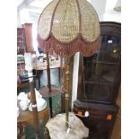 MARBLE AND BRASS TABLE STANDARD LAMP WITH A CANED AND TASSELLED SHADE. (NEEDS RE-WIRING)