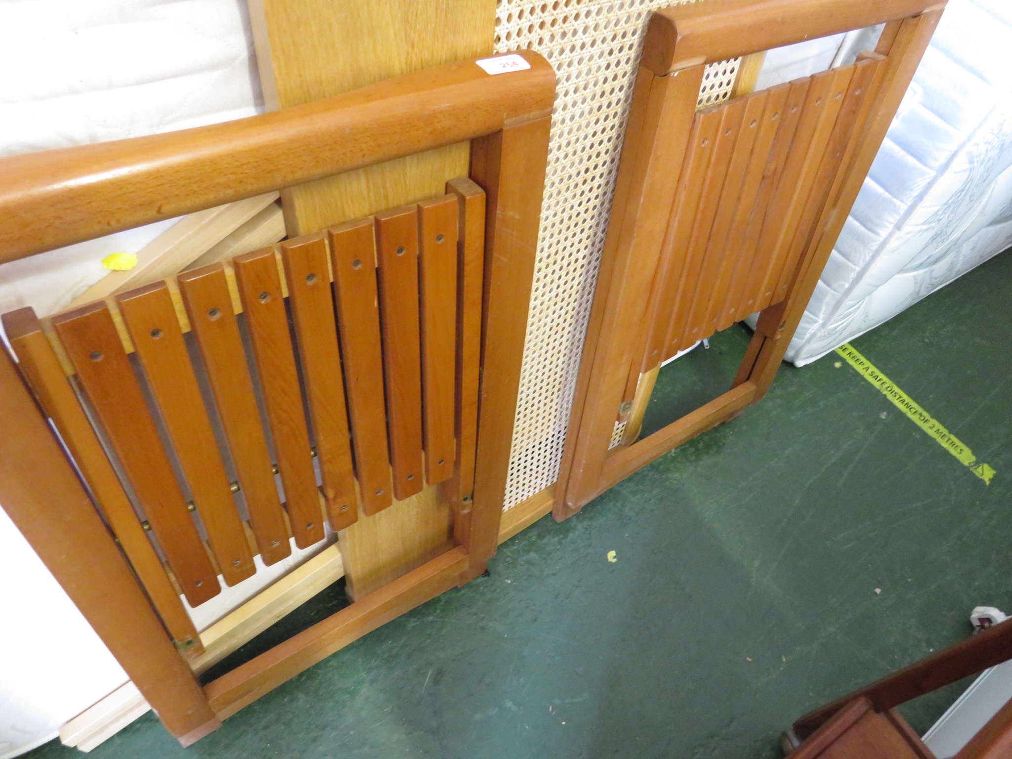 TWO FOLDING WOODEN CHAIRS TOGETHER WITH A SINGLE WOODEN HEADBOARD