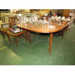 A TEAK EXTENDING DINING TABLE, TOGETHER WITH FIVE G-PLAN TEAK FRAMED DINING CHAIR FRAMES WITH