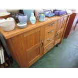 MODERN LIGHT OAK SMALL SIDEBOARD WITH FOUR CENTRAL DRAWERS AND CAST METAL HANDLES.