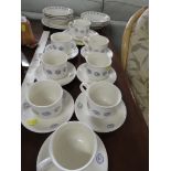 DINNER AND TEA WARE WITH A BLUE ON WHITE SWIRLED PATTERN.