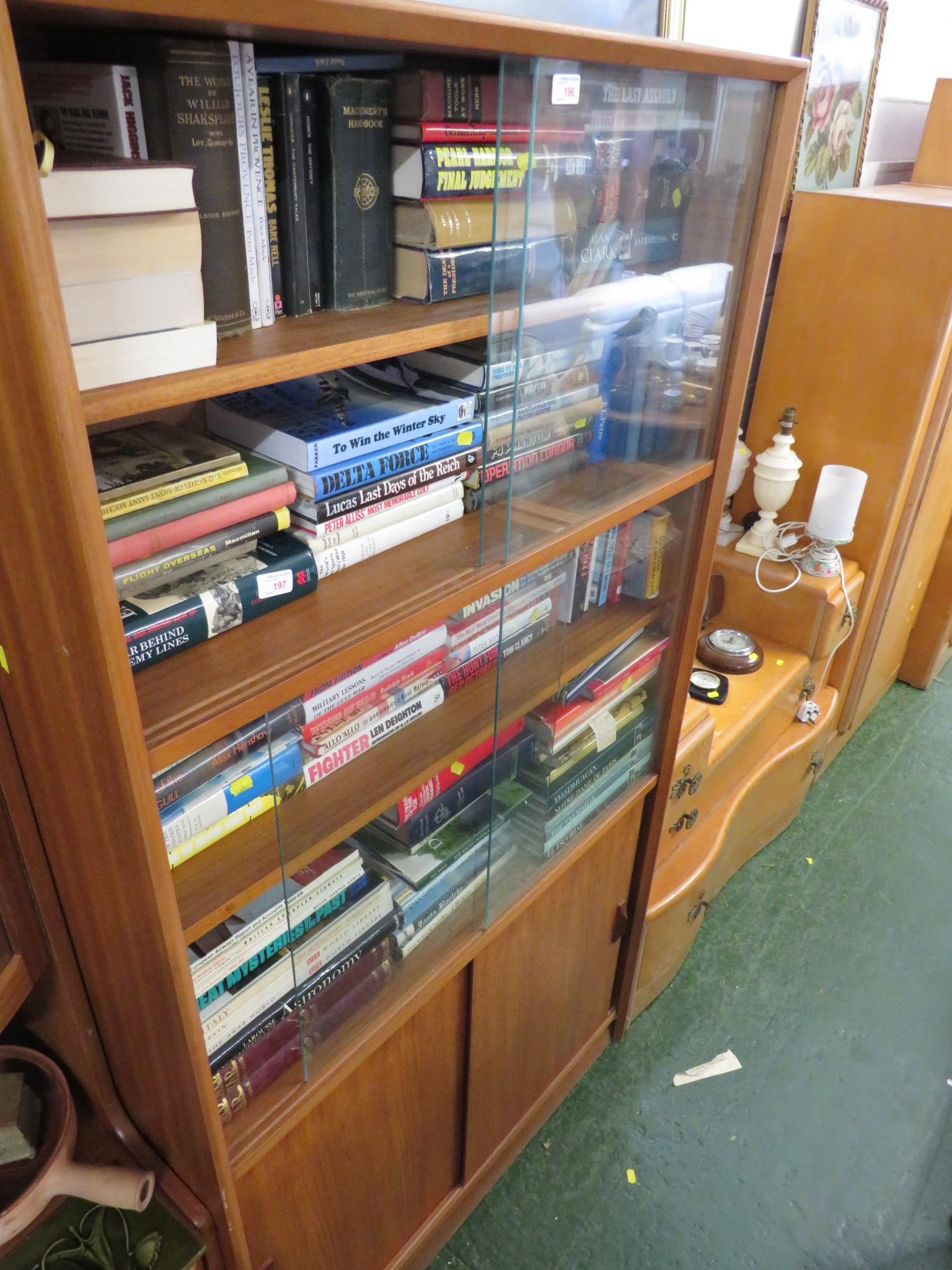 GIBBS FURNITURE TEAK BOOK CASE WITH SLIDING GLASS DOORS AND TWO SLIDING CUPBOARD DOORS TO BASE.