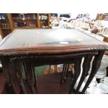 NEST OF THREE MAHOGANY VENEER TABLES.