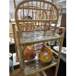 A CANED FRAMED TWO TIER SIDE TABLE TOGETHER WITH A MAGAZINE RACK.