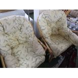 PAIR OF RATTAN FRAMED CONSERVATORY ARMCHAIRS WITH FOLIATE PATTERNED CUSHIONS, AND A GLASS TOP