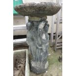 A COMPOSITE STONE BIRD BATH ON FIGURAL COLUMN