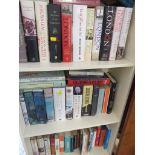 FOUR SHELVES OF FICTION AND REFERENCE BOOKS.