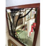 RECTANGULAR PICTORIAL WALL MIRROR DEPICTING COUPLE IN TREES WITH BICYCLES, IN A WOODEN FRAME