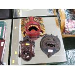 THREE CARVED WOODEN FACE MASKS.