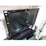 PANASONIC VIERA 37 INCH LCD TELEVISION ATTACHED TO A THREE TIER BLACK GLASS TV STAND, WITH REMOTE