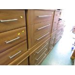 WOOD EFFECT SUITE OF BEDROOM FURNITURE COMPRISING TWO THREE-DRAWER CHESTS, A TEN DRAWER CHEST AND