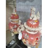 PAIR OF DECORATED FAR EASTERN JARS WITH LIDS, WITH FOO DOG MOUNTS AND STANDING ON THREE PAW FEET,