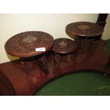 THREE SMALL CARVED AND INLAID OCCASIONAL TABLES ON FOLDING TRI-FORM BASES