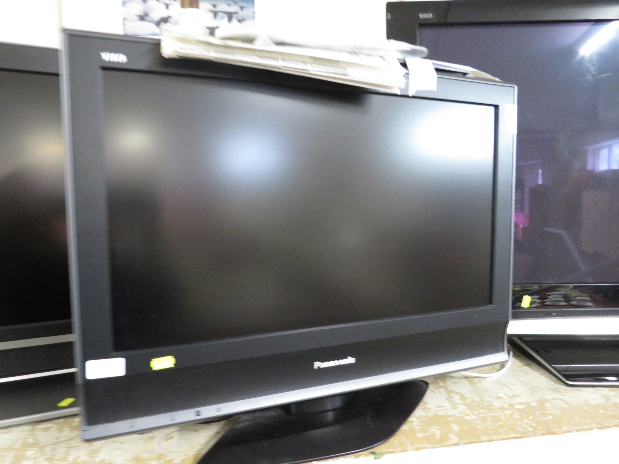 A PANASONIC 26 INCH VIERA LCD TELEVISION WITH REMOTE CONTROL AND INSTRUCTIONS.