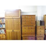 A COMPOSITE PINE BEDROOM SUITE COMPRISING A DOUBLE WARDROBE WITH TOP BOX, THREE CHESTS OF FOUR