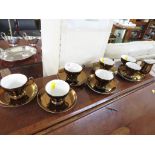 SET OF SIX CHINA COFFEE CUPS AND SAUCERS, WITH A BRONZED GLAZE.