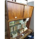 TEAK GLAZED ILLUMINATED WALL MOUNTING DISPLAY CABINET TOGETHER WITH ONE OTHER TEAK CUPBOARD