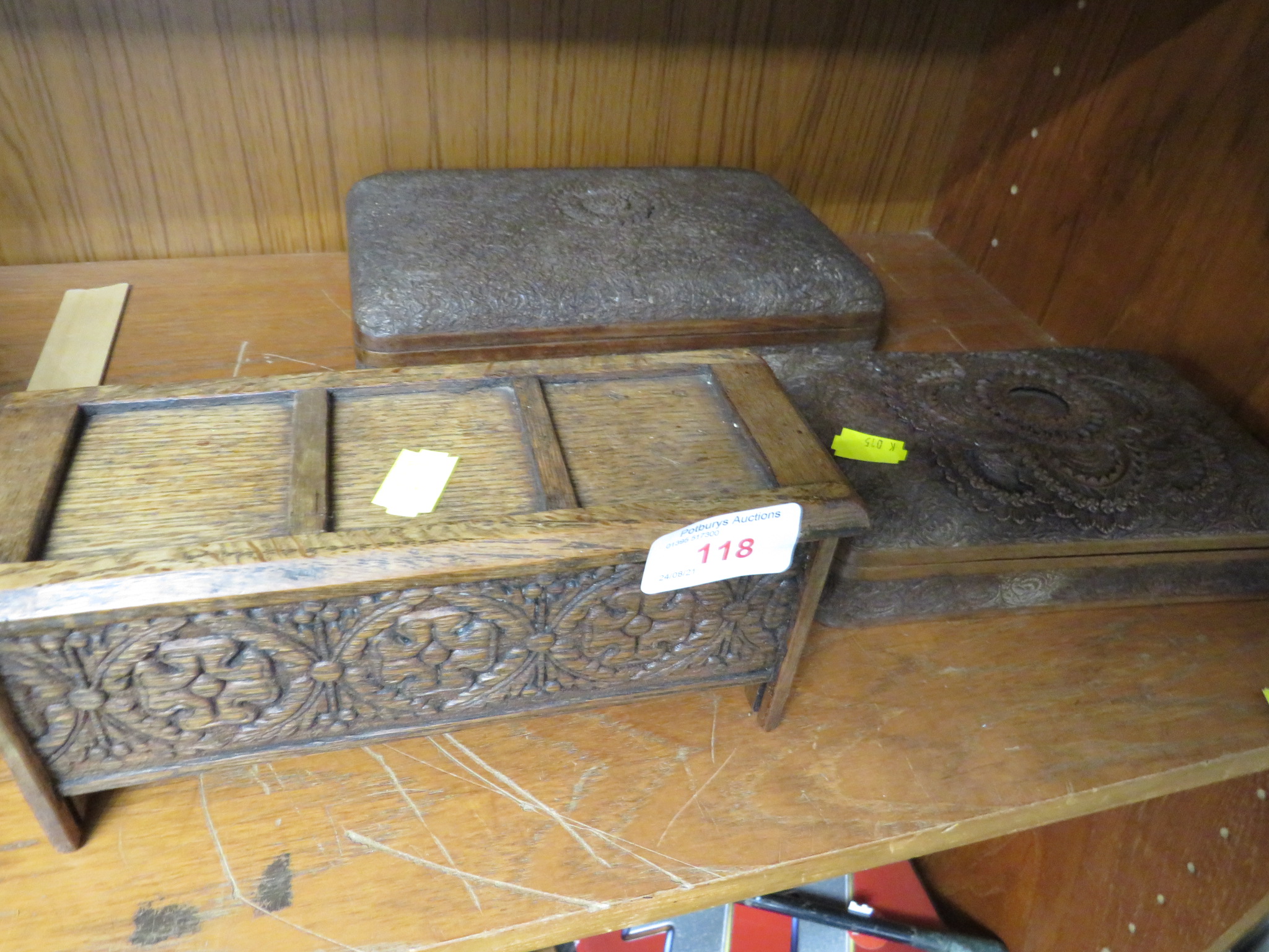 CARVED WOODEN CIGARETTE BOX MODELLED AS A COFFER, AND TWO OTHER CARVED WOODEN CIGARETTE BOXES