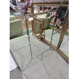 A LARGE RECTANGULAR WALL MIRROR WITH BROAD MIRRORED MARGINS