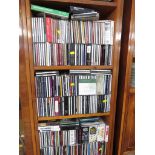 FOUR SHELVES OF CD'S , DVD'S AND AUDIO CASSETTES.