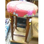 A WOODEN STOOL WITH UPOLSTED SEAT. *