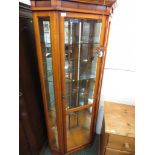 MAHOGANY VENEERED GLAZED AND ILLUMINATED CORNER DISPLAY CABINET.