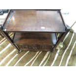 STAINED OAK TEA TROLLEY WITH TWO DRAWERS. *
