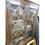 OLD CHARM FURNITURE STAINED OAK DISPLAY CABINET WITH GLAZED LEADED DOORS. *